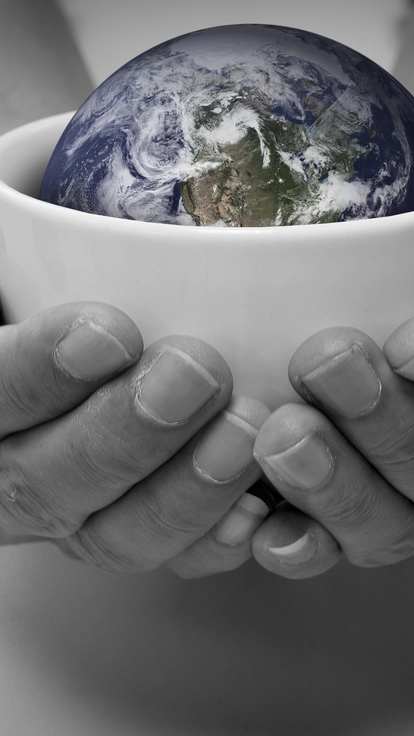 Earth sits in a white bowl that is being held in someones hands