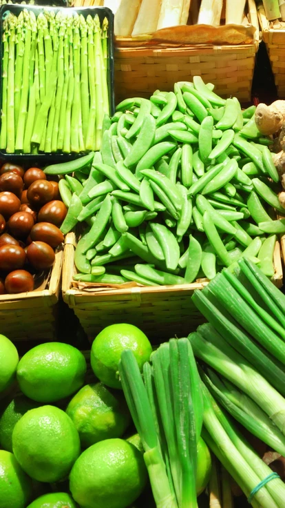 lots of fresh vegetables laid out at a market stall